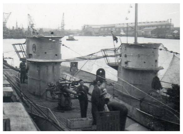 U 30 (Type VII A) moored by the dock carrying a modified conning tower (of the original) with wave deflector, small wind deflector, trunk air intake and the emblem has changed position over the lights of Navigation and the AA gun on the platform behind the conning tower. For its part U 99, in row, also carries a modified conning tower with wave deflector, small wind deflector, AA gun on a platform behind the conning towerl, raised periscope with victory pennants........................................