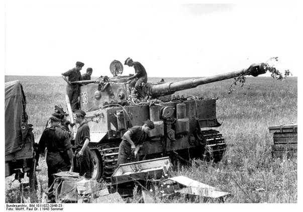 The crew loads the heavy projectiles one by one into the tank...................