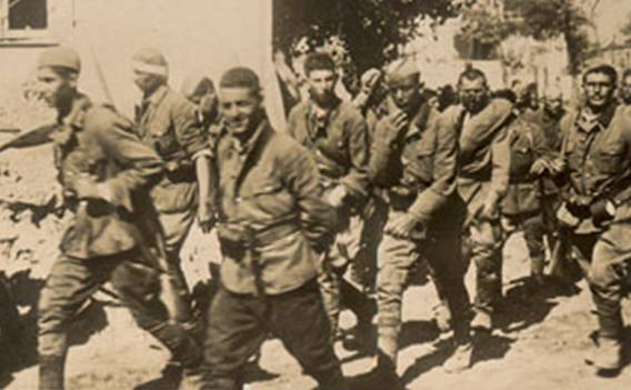 The Company of Russians volunteers against the Bolshevism marching  through Isjum - 26 of June of 1942.