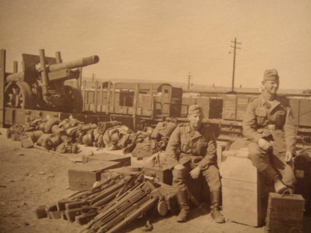 At the station yards. In the photo it is observed what it seems material of topographic measurement (tripods) and cases (with the instruments). In the back ground on a wagon a Soviet howitzer of 152 mm? And the personal equipment of the soldiers.