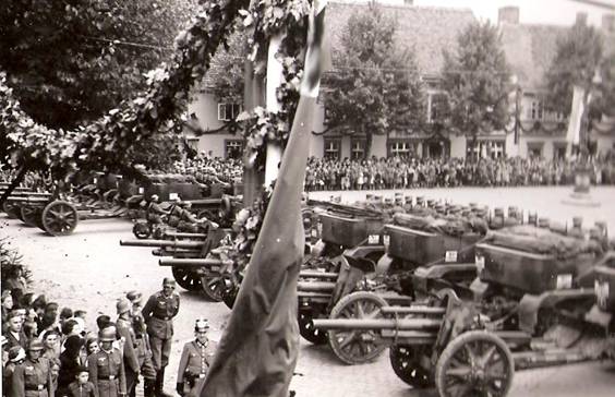 Military parade in the marketplace (each battery composed of four guns).