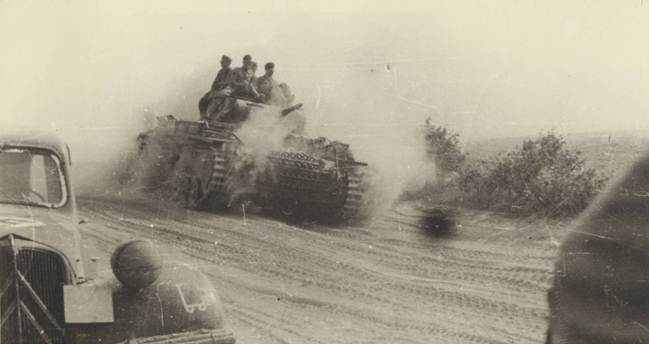 A Pz Kw III E / F of the 18. Pz rolling down a dusty path at the beginning of the campaign, in the foreground a Citroen?...............................