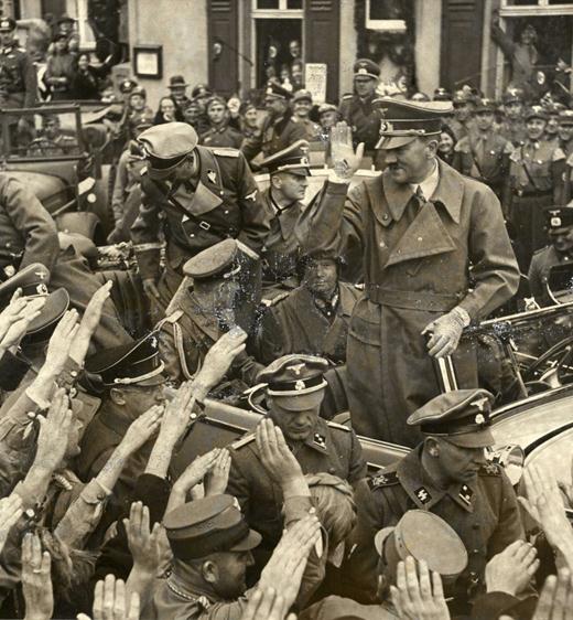 Hitler received the enthusiastic greeting of the population; the General behind him was Walter von Reichenau.......................