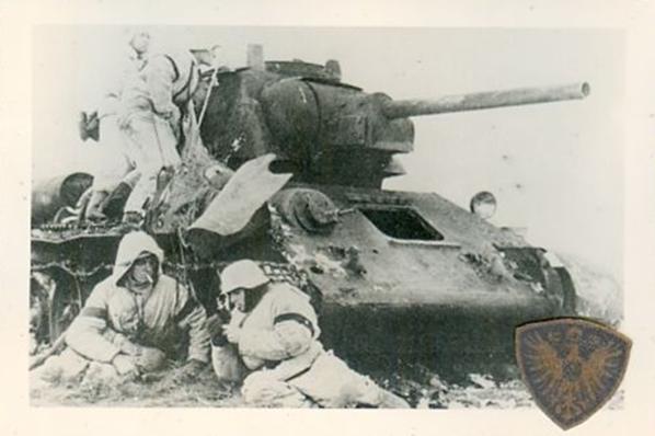 Soldiers of the the SS Totenkopf Division taking advantage of a disabled T-34...............