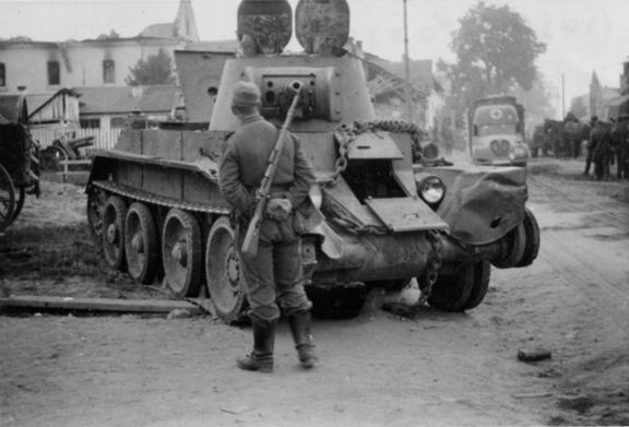 German soldiers in Niemirow observe a knocked out BT-7, down the street moves an ambulance Peugeot DK5.........................