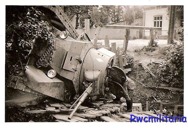 Jaworow; a soldier of the 1. GD checking a BT-7 of the 53 Tank Reg. disabled in struggles ..................