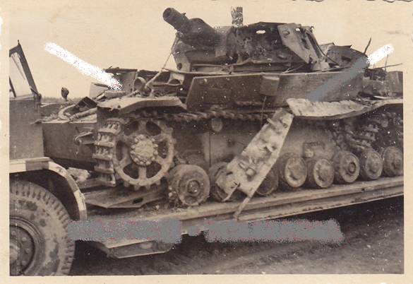 A knocked out Pz Kw IV tank loaded on a Sd Ah 116 trailer.....................