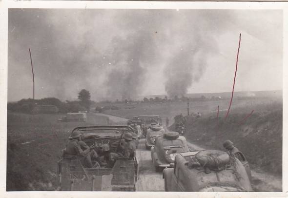 Motorized column of the 125. ID approaches the town of Nemirow, clouds of black smoke raised from the village as a result of the fighting that has taken place there .................
