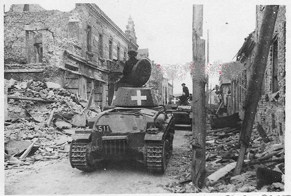 A column of Pz Kw 35 (t) rolling through a destroyed Polish city ................................