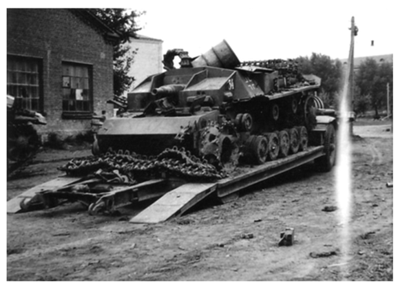 The Stug III Ausf. B No. 34 of Stug. Abt. 192 severely damaged and loaded on a trailer Sd. Ah 116..................................
