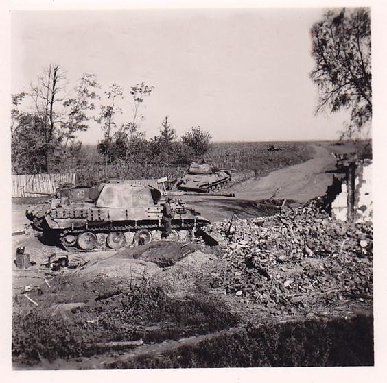 A Pz Kw V &quot;Panther&quot; and disabled Soviet tanks on the edge of a village - Kursk 1943............................