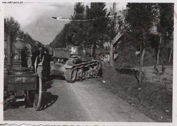 A Pz Kw 35 (t) stopped in a Polish secondary road being surpassed by a horse-drawn column (In the foreground a field kitchen) ................................