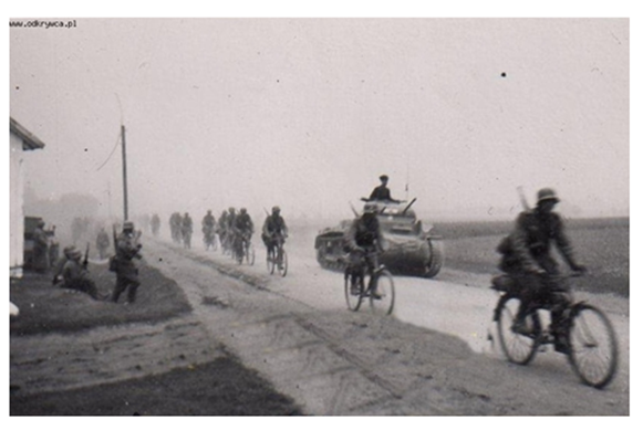 A patrol of cyclists running on a dusty Polish road; in the picture a Pz Kw II Ausf a/b...............................