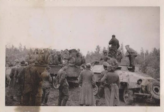 A Sd Kfz 251 carrying Russian prisoners in a trailer...........................................