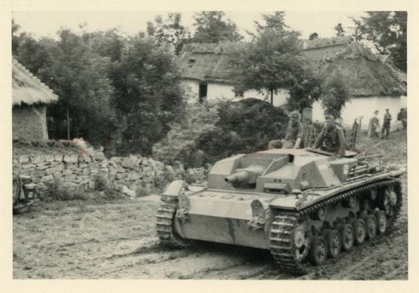 A StuG III Ausf. B rolling through a hamlet with its thatched houses........................................