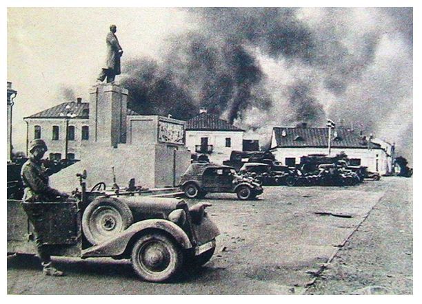 German motorized elements stopped in Lenin Square. In the background the city in flames................................