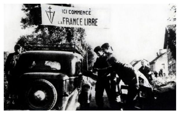 Group of the FFI in a village near Mont-Mouchet; the sign indicates: Here begins the free France.......................