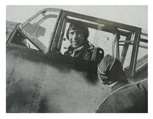 Werner Mölders smiling on the ground aboard his Bf-109; an impact received during the recent air combat is observed on the cockpit...................