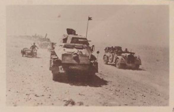 A German motorized column marching down a track in the desert, led by a Panzerspähwagen Sd Kfz 231 (8-rad) of the Aufkl. Abt. 3............