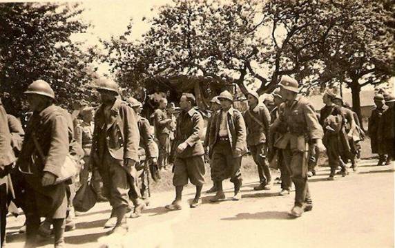 German soldiers escorting some French POWs to the rear - May 1940.