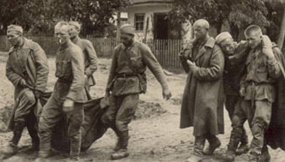 Russian soldiers carrying their wounded comrades back.