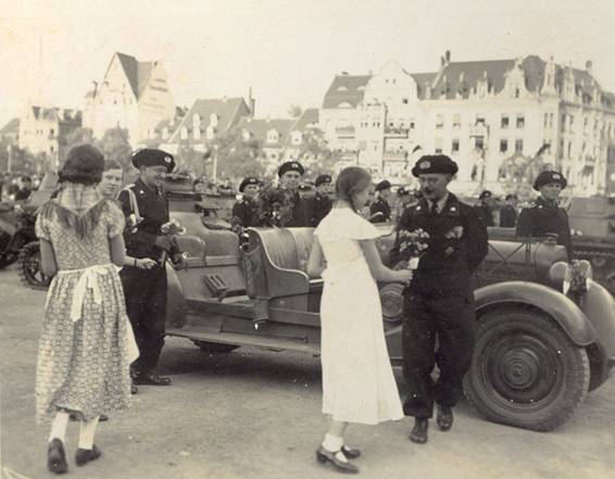 Young ladies giving flowers to the newly arrived in town..........(any idea who was he?)
