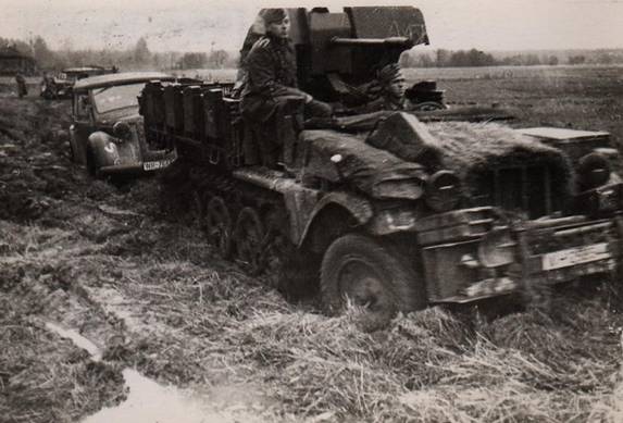 A Sd Kfz 10  with a 20 mm AA gun, towing a staff car through the mud - somewhere in Russia fall 1941.