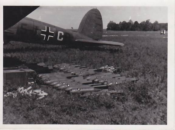 A Load of bombs next to a He-111P of the HQ of the III. / KG 4 ..............................