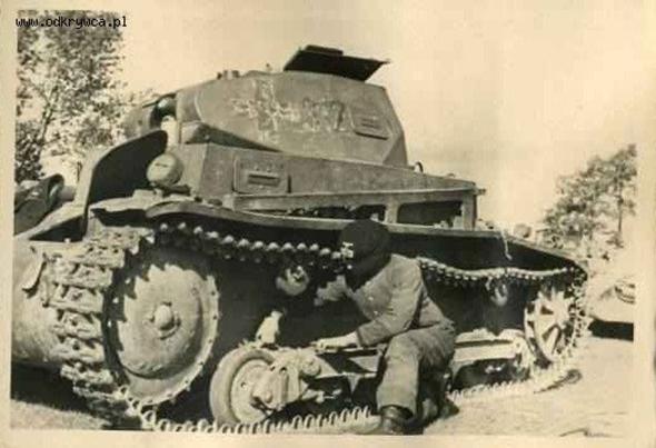 A crew-member checking the running gear of a Pz Kw II a/b? ; interesting, the white cross was removed ...............