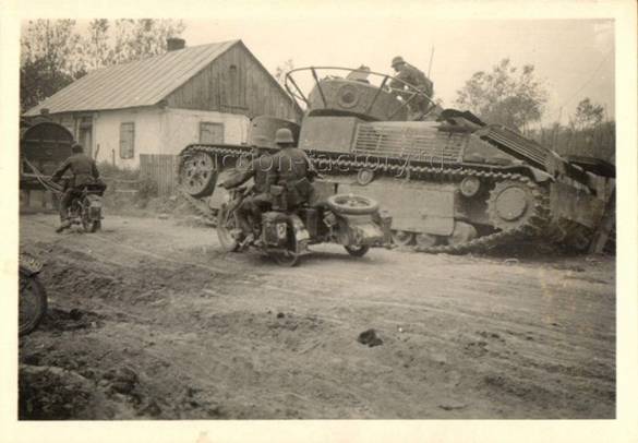 German soldiers inspecting a T-28 abandoned at the roadside .................................