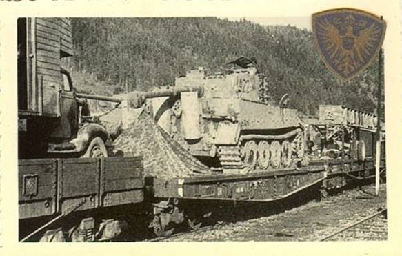 A Pz Kw VI Tiger being transported by rail, the tent of the crew is observed in the same flat car...........<br /> Deut.Panzer VI, Tiger, 3.Pz-Div.TK, Pz-Reg.3, Tarn, Kennung, Bahnverladung, Grodno, 1944