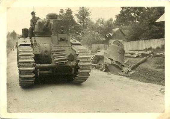 A Pz Kw B2 (F) surpassing the remnants of an enemy vehicle .....................