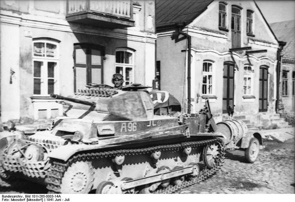 An old type Pz Kw IIa / b of PR 29 in a town in the Baltic; note the trailer with extra fuel.................