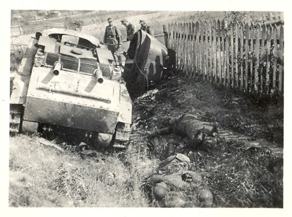 A Soviet light tank BT-7 and its crew lying dead to one side......................