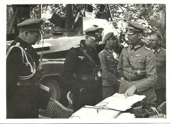 General Georg-Hans Reinhardt (1888-1963), 2nd from right, and General Max von Hartlieb-Walsporn (1883-1959), 2nd from left, in front of an armored funkwagen (8rad) Sd. kfz. 232 with their adjutants talking about the attack planning of the 4. Pz-Div in the Polish campaign in 1939. Adjutant Hauptmann von Harling, left....................