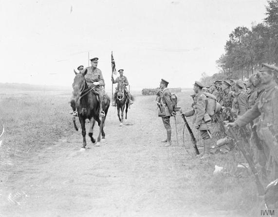 General Sir Douglas Haig, Commander of the British Expeditionary Force, on horseback, accompanied by a standard bearer, reviewing Canadian troops following the Battle of Amiens.......................