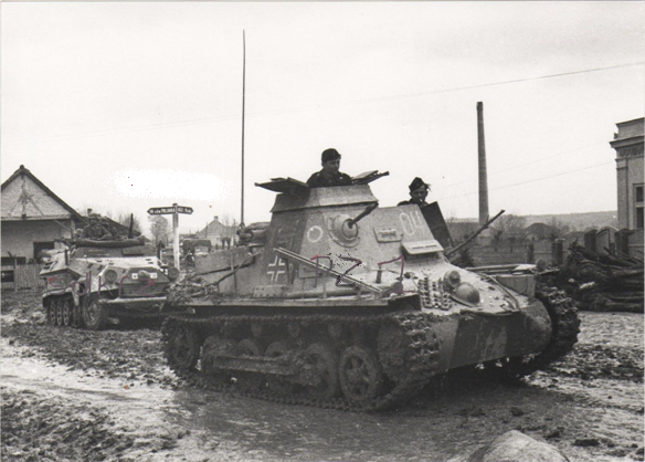 Close view of a Panzerbefehlswagen I Ausf. B (265 Sd.Kfz.) with numeral  04 around Palanka (Serbia); behind a Schützenpanzerwagen SdKfz 251 with the emblem of the 11. Pz ........................