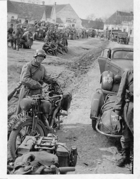 Logistics column during a break; in the foreground a couple of motorcycles and one with sidecar..............................