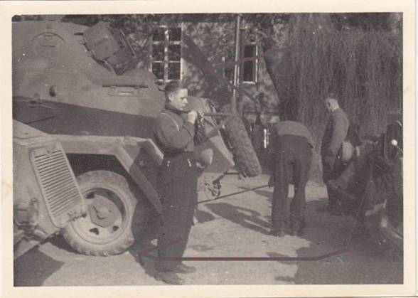 The crew of a Funkwagen Sd Kfz 232 (6-rad) at rest in the assembly area during the occupation of the Sudetenland......................