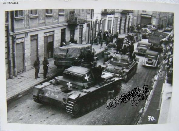 A Pz Kw III Ausf. D (Marta) leads the way through the crowded streets ..................................... ......
