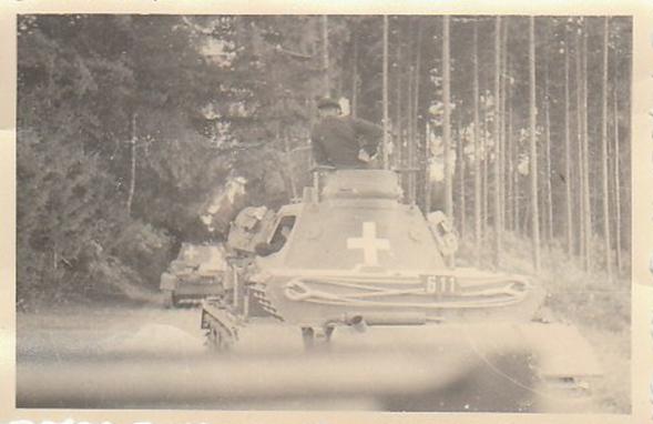 An armored column rolling through a wooded area ........................