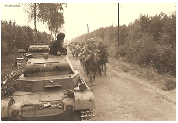 A Pz Kw II in the lead of an armored column stopped at the roadside; in the same direction a horse-drawn column..........................................