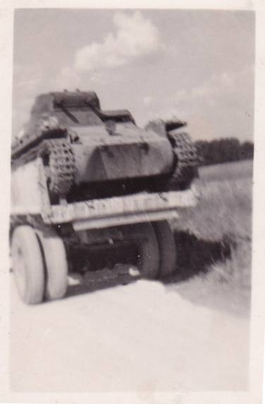 A Pz Kw I on the back of a truck towards the workshop of the Panzer Division................................