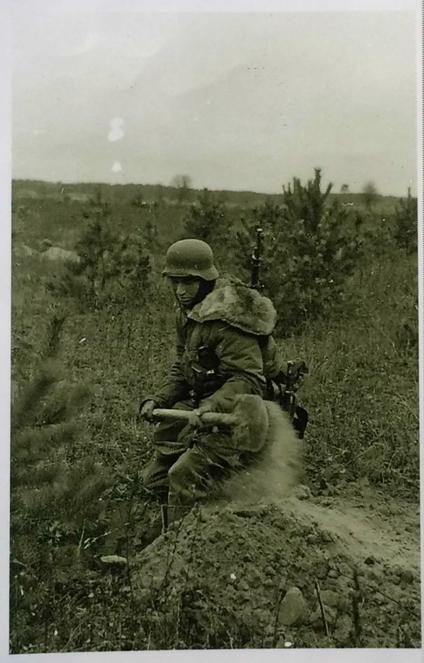 A member of the Waffen SS, somewhere on the eastern front, digging their defensive position to resist the next attack .....................
